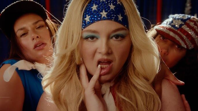 Meg Stalter launches her music career with “Prettiest Girl In America,” a campy, hyper-pop video packed with rivalry, beauty pageants and satire.
