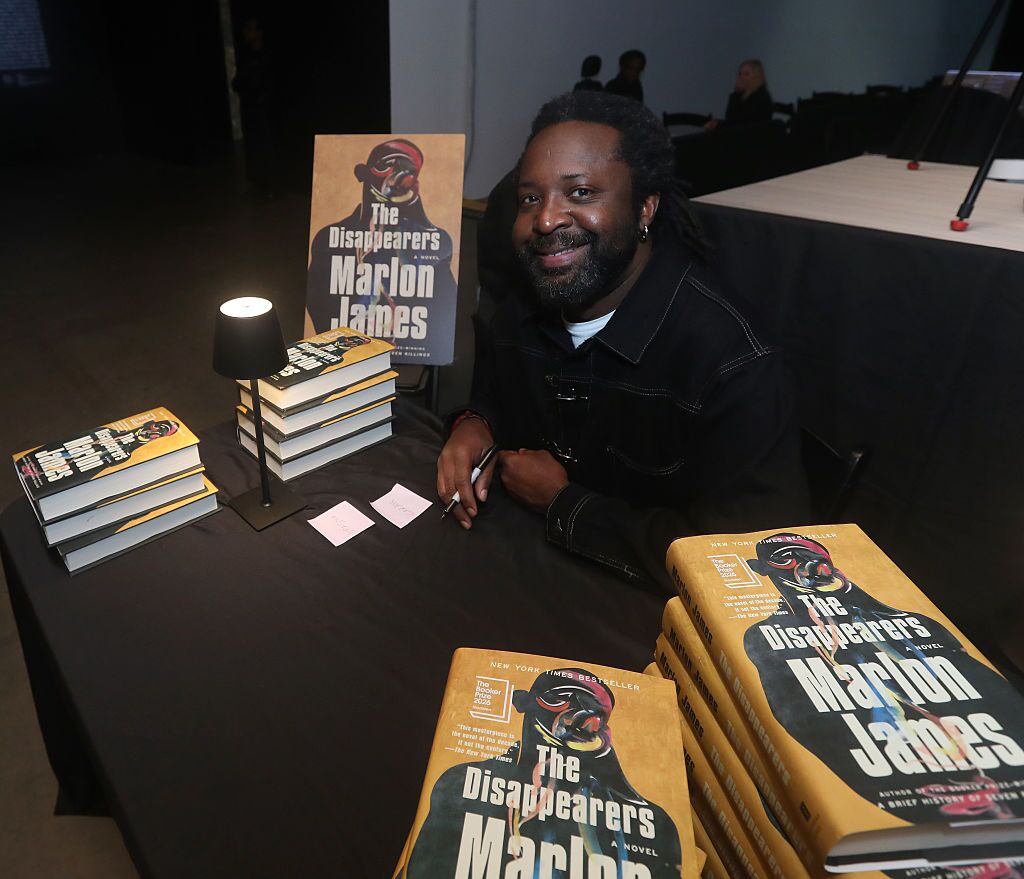 Marlon James smiles beside copies of The Disappearers at Pioneer Works in Brooklyn.
