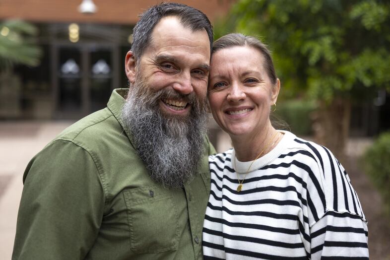 Shane and Jenn DeGross standing together outside