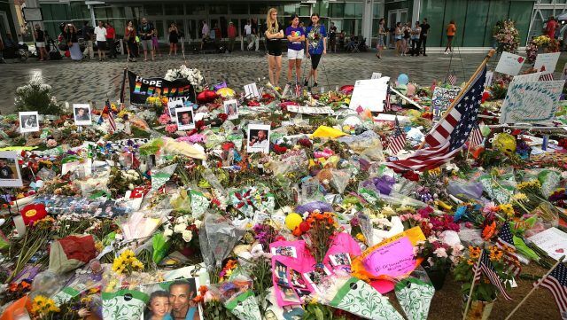 People visit a memorial down the street from Pulse nightclub on June 19, 2016 in Orlando, Florida. In what has been described as the deadliest mass shooting in American history, Omar Mir Sediq Mateen killed 49 people at a popular gay nightclub early last Sunday. The attack left 53 people injured, but authorities and local leaders are still trying to come to terms with it.